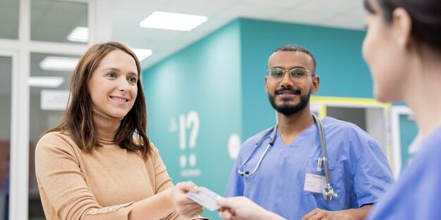 young-cheerful-patient-giving-credit-card-receptionist-clinics-pay-medical-service-after-consultation-treatment_274679-5185